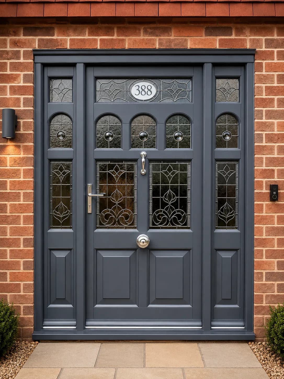 Bespoke grey period entrance door with leaded and bevelled glazing, flanking sidelights and a numbered fanlight, set in a brick surround
