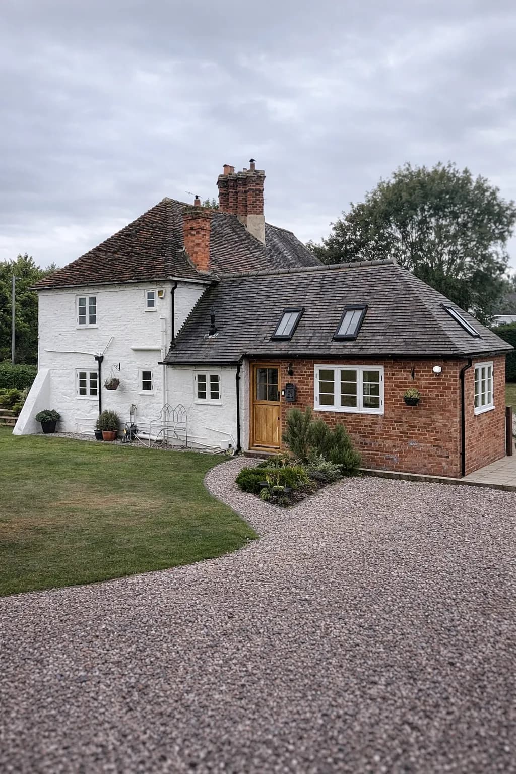 Grade II listed farmhouse in Worcestershire, white-painted brick with a single-storey brick extension, oak entrance door and Accoya flush casement windows