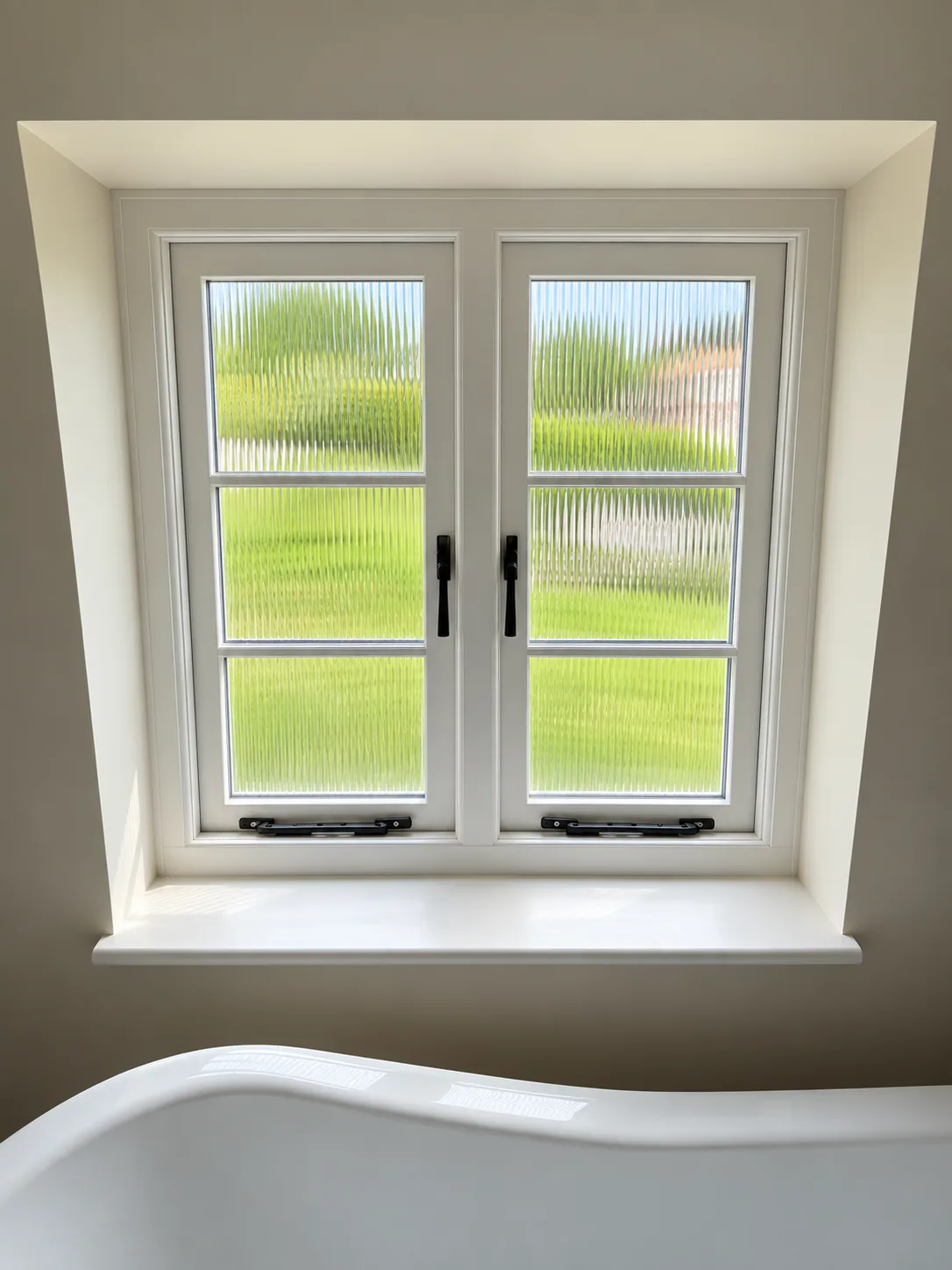 Accoya flush casement window seen from inside a bathroom, painted white with reeded obscure glass and beeswax monkey-tail stays